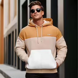 a man is standing in front of a building wearing shades and holding a white bag