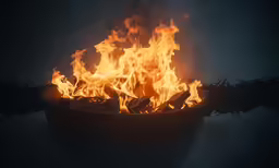 a fire burning inside of a black bowl