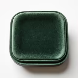 an empty square green plate on a white surface
