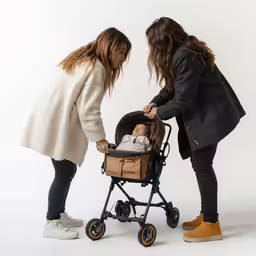 two women pushing a child in a buggy