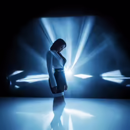 a woman in dress walking on a stage
