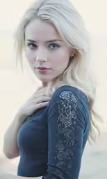 a beautiful blond with blue eyes and long hair is posing for a photo