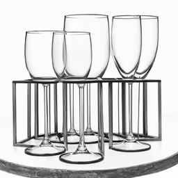 four empty wine glasses lined up on a stand