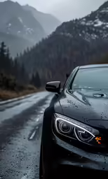a car driving on the road next to a tall mountain