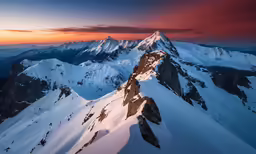 a view from the top of a mountain during sunset
