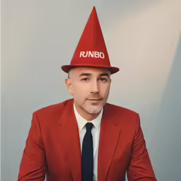 a man with a red hat on sitting down