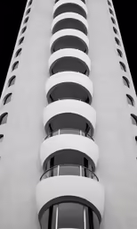 the front side of an apartment building with circular balconies