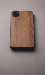 a cell phone is laying on a gray surface