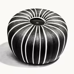 a striped black and white ottoman made of wood