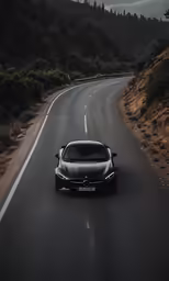 the black car is driving on the road