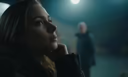 a woman looks up at someone while standing next to her