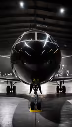 an airplane is shown in a dimly lit hanger