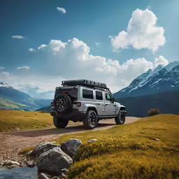 the jeep is traveling on a rocky road in the mountains