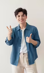 a young man gives the thumbs up sign