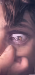 a close up of someone looking through a hole in the eye