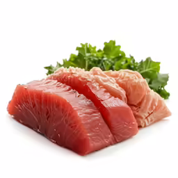 a raw piece of fish with green leafy greens