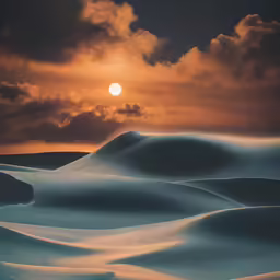sun shining through clouds above sand dunes