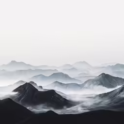 a picture of mountains with lots of fog