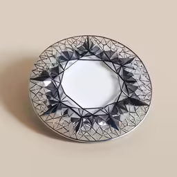 a decorative plate sitting on a white table