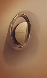 a metal object with a brown background
