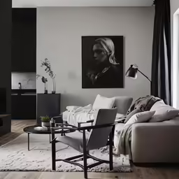 a modern living room with an abstract painting on the wall
