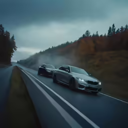 the two bmws are driving down the road together