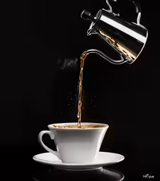 a cup of coffee being filled with liquid