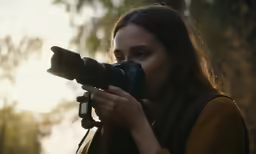 a woman is holding up a camera to take pictures