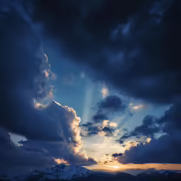 a large cloud with the sun going down in a sunset