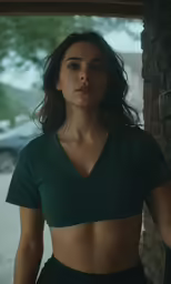 a woman with a green top posing for a picture
