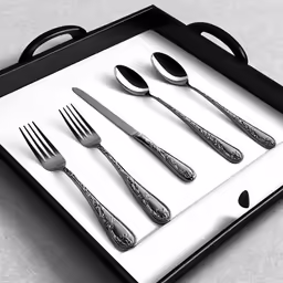 a black tray topped with silverware on top of a table