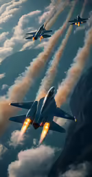 three military jets flying low over the mountains