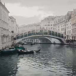 boats are floating down the water near buildings