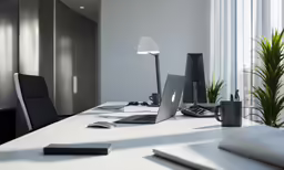 a white table with a laptop, mouse and monitor