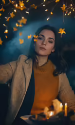 a woman in a sweater looks intently into the distance and lit candles around her