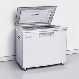 a silver cooler sits on top of a white wall