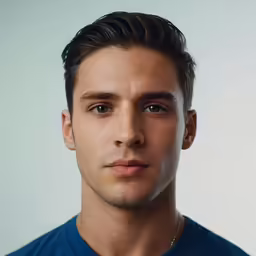 a man in a blue shirt and a gold necktie