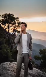 a man standing on top of a mountain with his hand near his mouth