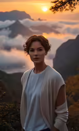 a woman standing in front of the mountains with a view of clouds