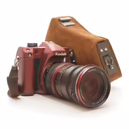 an old camera next to a roll of film