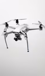 a small white device is flying through the sky