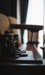 an old camera sits on a desk in the living room