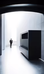 a man is walking in a building with a very large metal object
