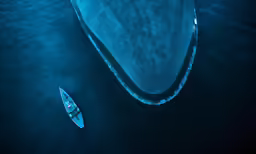 two boats traveling side by side near each other in the water