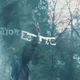the face of a man in front of trees with a sign over it reading toronto electric