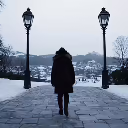 a woman walking down the middle of a sidewalk