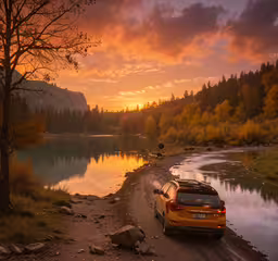 a yellow suv parked along a quiet lake,a yellow vehicle sits on a river side as the sun rises