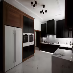 a white and black kitchen with wood trim