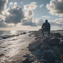 a man sitting on the rocks at the beach