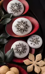 red plates with three decoratively decorated dessert pieces